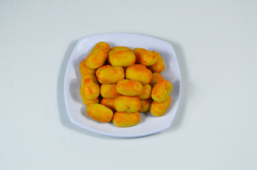 Kue nastar or pineapple tart. indonesian eid snack (kue lebaran). on a white plate. bright mood style. perfect for recipe, article, catalogue, or any commercial purposes.
