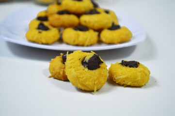Chocolate thumbprint cookies. Homemade Thumbprint Cookies filled with chocolate jam and grated cheese. Served on a white plate are usually served to celebrate Eid al-Fitr
