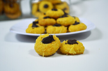 Chocolate thumbprint cookies. Homemade Thumbprint Cookies filled with chocolate jam and grated cheese. Served on a white plate are usually served to celebrate Eid al-Fitr
