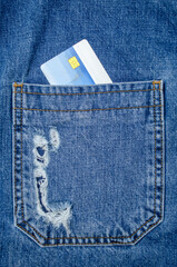 Credit card in blue jeans pocket close up