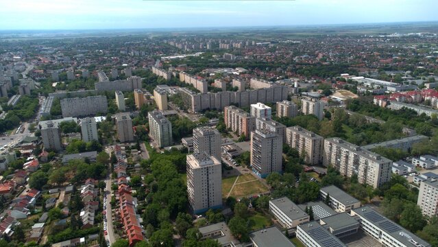 Aerial cityscape, Debrecen, Hungary. Urban skyline, modern highrise panel flats and apartment complexes. Residential blocks, roads, rooftops, and greenery. Eastern and Central European city. Block of 