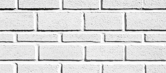Obraz premium White brick wall texture. Regular rectangular shapes, even spacing, creates a simple, neutral, and classic pattern