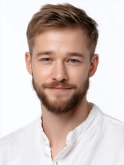 Obraz premium Bright smiling young man with short light brown hair and beard wea a white shirt against a plain white background, showcasing friendly and approachable expression white background