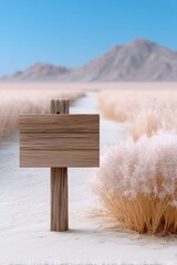 Naklejka premium Minimalist wooden signpost on a desert landscape with dry bushes and distant mountains under a clear blue sky emphasizing tranquility and natural scenery