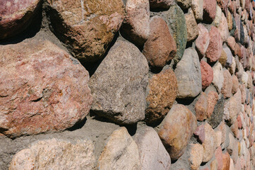 Close-up of the texture of a cobblestone made from mountain building stone.