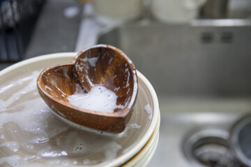 Dirty soapy dishes on the kitchen sink