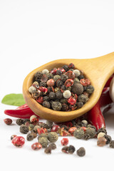 Wooden spoon filled with spices isolated on white background.