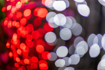 Abstract colorful bokeh orbs on dark background, vibrant defocused light dots pattern