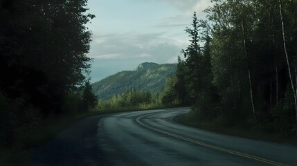 Fototapeta premium A peaceful scenic road winds through a verdant forest climbing up the mountainous terrain and offering a tranquil natural escape