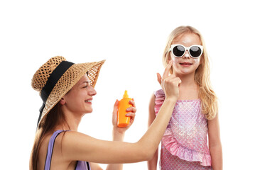 Smiling mother applying sun protection product onto her daughter's cheeks on white background