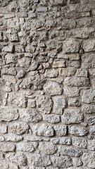 Rustic stone wall texture with natural colors and weathered appearance