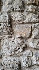 Fototapeta premium Textured stone wall in an old building showcases historical craftsmanship and durability