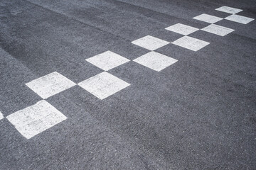 Close-up of road markings at the race start and finish.