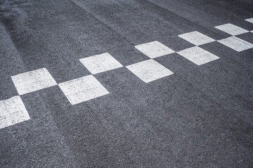 Close-up Starting and finishing grid asphalt. Checkered line on racing motorsport track.