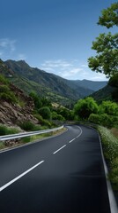 Serpentine Road Curves through Verdant Valley in Mountainous Landscape under Sunny Blue Sky