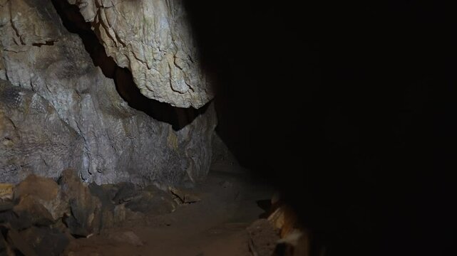 Inside of a beautiful colourful cave. Flowstones, stalactites and stalagmites lighted in different vivid colours.