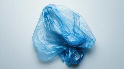 Fototapeta premium A bright, transparent plastic rain poncho with a hood, neatly folded.