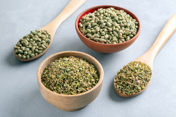 A bowl full of dried and ground natural mountain thyme on light background
