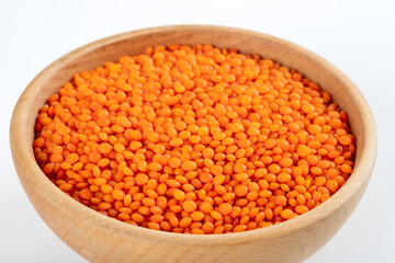 A bowl of red lentils. Close-up on a white background
