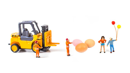 miniature people and egg isolated on white background.