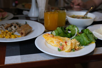 Stuffed omelette with tomatoes and spinach on light background with copy space. Top view, flat lay. High quality photo
