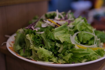 Fresh green salad in plate made of green leaves mix. Variety of healthy fresh harvested eatable...