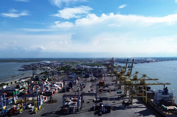 Aerial view of Belawan Port in Medan, Indonesia, showing cargo containers, cranes, and port activities. Shot on April 21, 2025