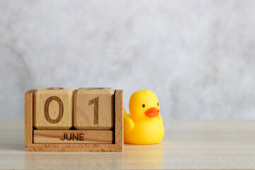 Wooden calendar showing june 01 with a rubber duck celebrating children's day