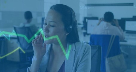 Female support rep wearing headset at monitors and gesturing at holographic graph overlay in office - Powered by Adobe