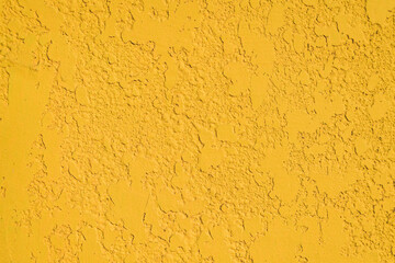 Close-up, the texture of the facade of decorative yellow plaster.