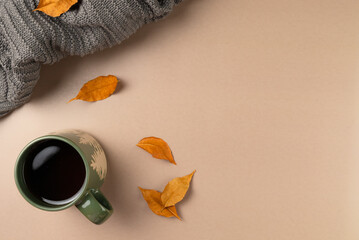 Cup of tea with leaves on beige background. Flat lay, top view. Copy space