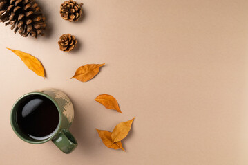 Cup of tea with leaves and cone on beige background. Flat lay, top view. Copy space
