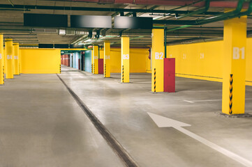 The background of an empty underground parking lot is yellow.