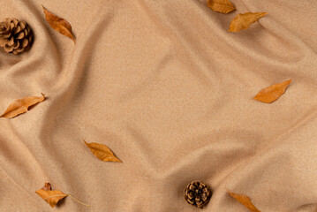Brown fabric with leaves as concept background. Copy space