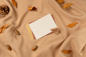 Empty white paper list on fabric background from above. Flat lay, top view.