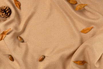 Brown fabric with leaves as concept background. Copy space