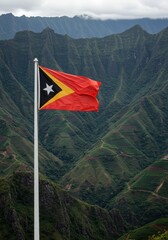 Waving Timorese Flag Symbolizing Independence Against the Rugged Mountainous Interior Landscape