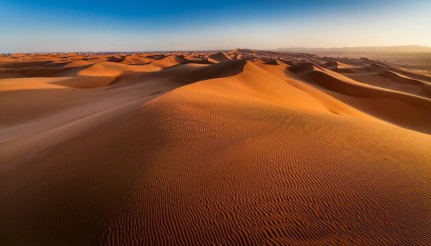 a stunning aerial view of an endless desert dune field with undulating waves of sand stretching as far as the eye can see