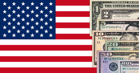 Banknotes of the United States of America of various denominations on the flag of the United States of America. US paper money