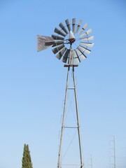old windmill against blue sky