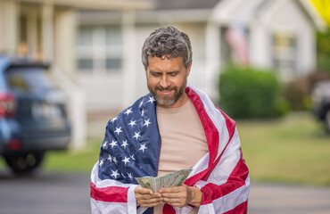 Paying tax in America. Value added tax. Taxation system. Patriotic man counting money. Man with...