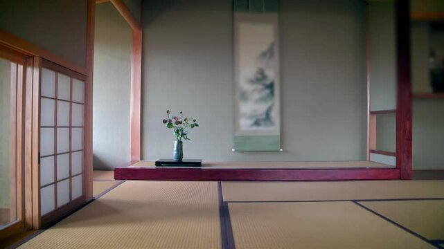 Traditional Japanese room with flower arrangement and hanging scroll, tatami mat flooring, wooden details, calm and serene atmosphere, minimalist nature-inspired interior design