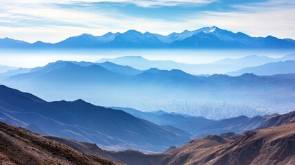 Misty mountain ranges layered in soft blue hues