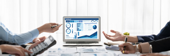 Business intelligence and data analysis concept. Analyst team working on financial data analysis dashboard on laptop screen as marketing indication for effective business strategic planning. Insight