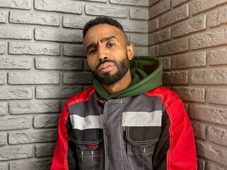 Portrait of a thoughtful, serious young man of African-American nationality with a beard close-up....