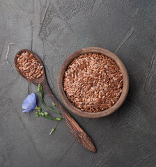 Flax seed on wooden plate