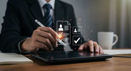 A person in a suit using a stylus on a tablet with digital checklist and profile icons displayed
