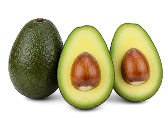 A whole avocado and two avocado halves with pits on a white background in a studio shot view