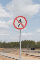 Road sign pedestrian traffic is prohibited. A sign forbidding people to enter the construction site. The movement of people on the territory of the building is prohibited.