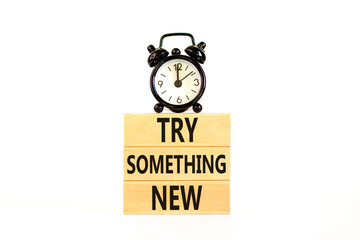 Try something new symbol. Concept words Try something new on beautiful block. Black alarm clock....